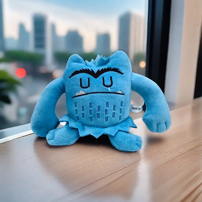 Blue Flooring Monster plush soft toy on a windowsill